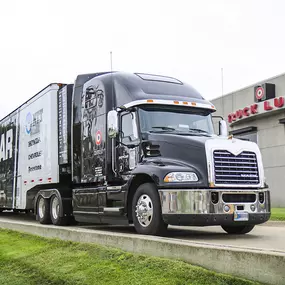 Housby Truck Lube Featuring A Black Mack Truck