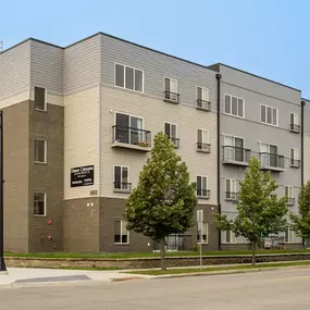 a large apartment building with trees in front of it