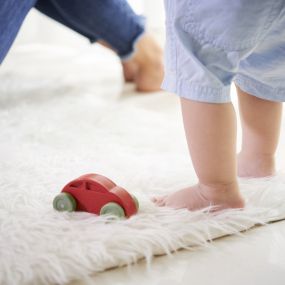 Mom and baby playing on clean carpet in Pueblo