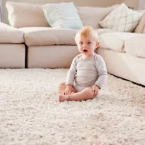 Young child sitting on clean carpets