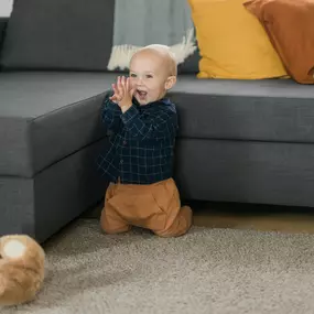 Young boy next to a couch after an expert upholstery cleaning in Canon City, CO