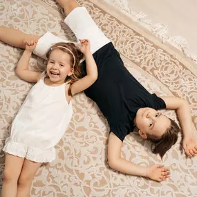 A couple of kids on a clean area rug in Pueblo, CO