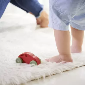 Mom and baby playing on clean carpet in Pueblo