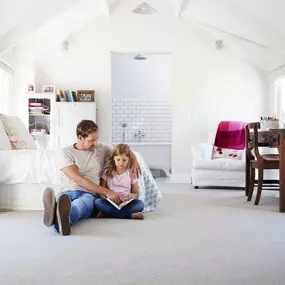 family sitting in a room after professional home cleaning in Pueblo