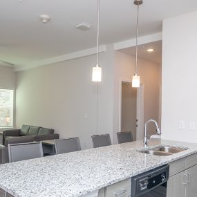 Spacious kitchen with open concept layout and granite countertops.