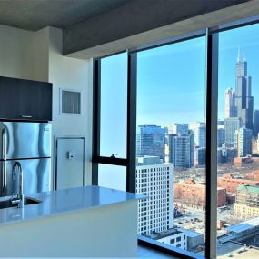 Penthouse kitchen with floor-to-ceiling views of Chicago