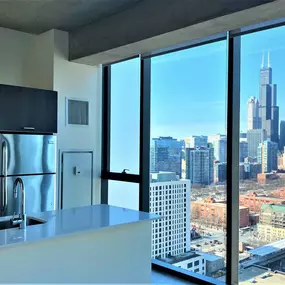 Penthouse kitchen with floor-to-ceiling views of Chicago