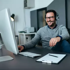 Employee using a VOIP connection to help a customer.