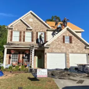 Photo of people working on roof top