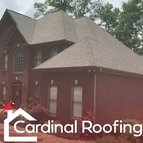 Brown asphalt shingle roof on home with brick siding