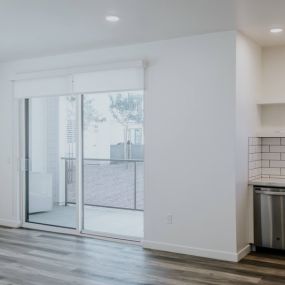 Beautiful wood plank inspired flooring and patio with a private patio off the living room at Park West Apartments in Bakersfield, CA