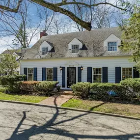 white house with roof repaired by Renaissance Roofing Inc