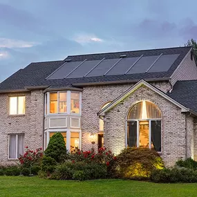 beautiful home at dusk with solar shingles installed by Renaissance Roofing