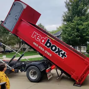 Elite dumpster getting dropped off