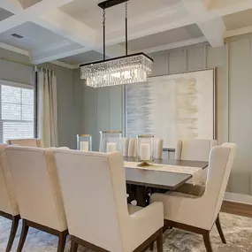 New construction 2-story home dining room with tray ceiling and dining table in DRB Homes Rowland Place community.