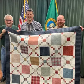 Quilt Patch Lane was honored to present this quilt on behalf of Quilts for Cops to a Spokane County Sheriff's Officer (pictured in center) who was recently injured in the line of duty. In attendance were Sheriff John Nowels and Randy Withrow representing Quilt Patch Lane.