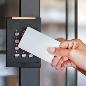 Woman using an access key card from Michael's Keys for secure entry at a facility in Colleyville, TX