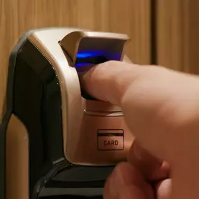 Individual using a fingerprint scanner on a door lock in Colleyville, TX, for secure access.