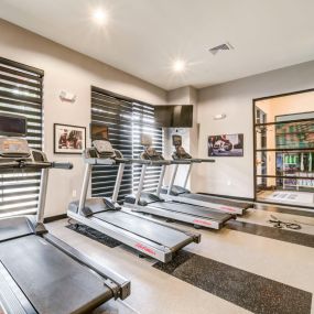 Fitness center with multiple cardio machines.