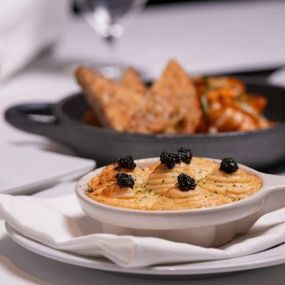 Maine Lobster Escargot with Chick Lobster, truffle mornay sauce, and topped with caviar