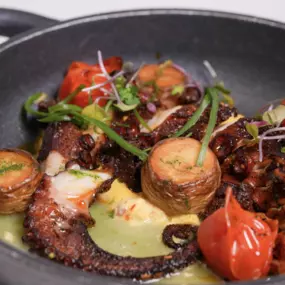 Wood Roasted Spanish Octopus—served with saffron aioli, crispy fingerling potatoes, crumbled Iberian pork, and chive oil