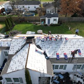 Class Roofing contractors working on a roof