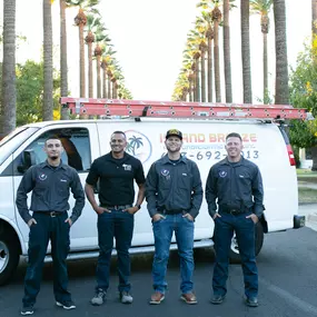 hvac employees standing in front of truck