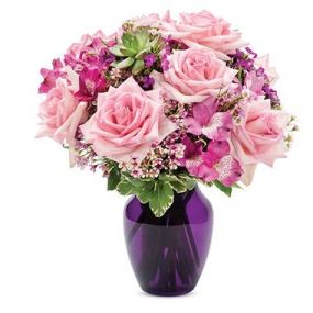 Let them know how you really feel with this stunning bouquet of pink roses, purple alstroemeria, purple dianthus and pink waxflower in a royal purple vase.