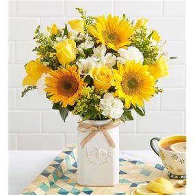 Get them buzzing for summer! Our unique, stylized bouquet is gathered with a mix of blooms in bright, happy yellow & white. Designed in our Sweet As Can Bee artisanal vase, featuring an adorable honey bee and raffia bow, it’s a gift that adds radiant beauty to any decor.