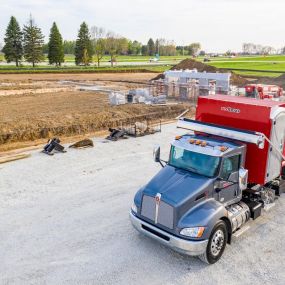 an elite dumpster being delivered to a jobsite in Denver