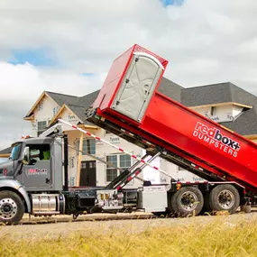 an elite dumpster being delivered to a jobsite in Denver