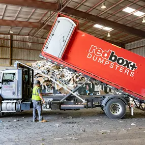 an elite dumpster being delivered to a jobsite in Denver