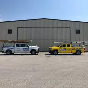 Absolute Overhead Door Service trucks outside the building