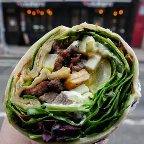 Underworld: Grilled Steak wrapped in orginal white flour dough with granny smith apples, pickles, toasted cashew nuts, goat cheese and white sesame sauce