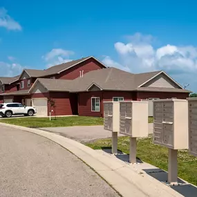 a house with three mailboxes in front of it at Prairie Crossing Townhomes