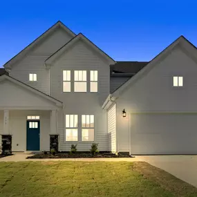 White two story home with 2 car garage at dusk in DRB Homes Anderson Grant