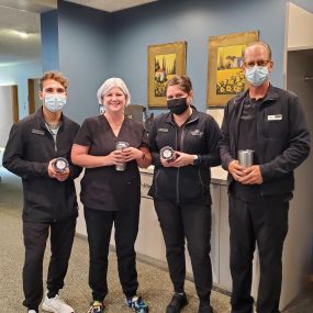 Michigan Eye Institute employees standing by the front desk.