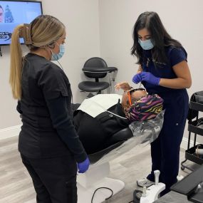 Angie And Dr. Sabir of Abc 123 Family Dental Haltom City Examine a Patient