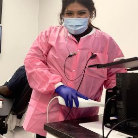 Dental Assistant Samantha Prepares A Patient For An Exam At Abc Family Dental