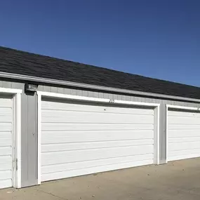 A row of white garage doors are closed.