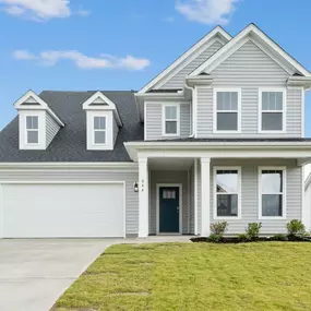 Two story single family home with gray siding and two car garage in DRB Homes Bellewood Forest community