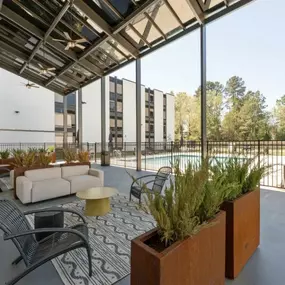 a lounge area with a couch and chairs and glass ceilings