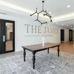 a conference room with a table and a chandelier