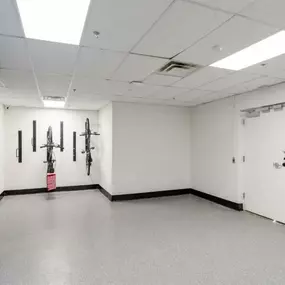 a large room with martial arts equipment on the wall