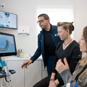 Modern Dentistry of New England team looking over a scan