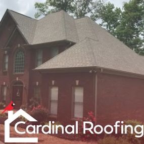 Brown asphalt shingle roof on home with brick siding