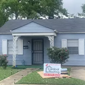 Light blue ranch house with gray asphalt shingle roof