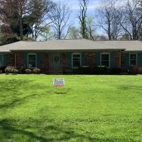 Brown brick home with blue double-hung windows