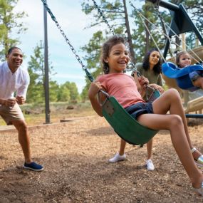 Kids on a swing set at Little America Flagstaff.