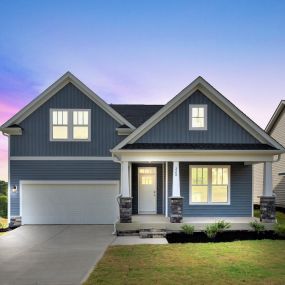 Two story single family home with blue siding and two car garages in the Cooper 3 plan with finished basement in DRB Homes Livingston Park